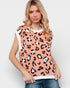 Woman wearing a sleeveless top with leopard print on a plain background