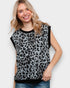 Woman wearing a leopard print sleeveless top against a plain background