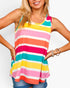 A woman wearing a colorful sleeveless tank top with horizontal stripes in pink, orange, teal, yellow, and white, paired with blue denim shorts against a light gray background.