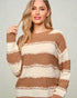 Woman wearing a brown and beige striped sweater against a plain background