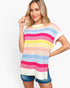 A woman wearing a colorful striped knit tunic sweater with short sleeves and denim shorts, posed against a clean white studio background.