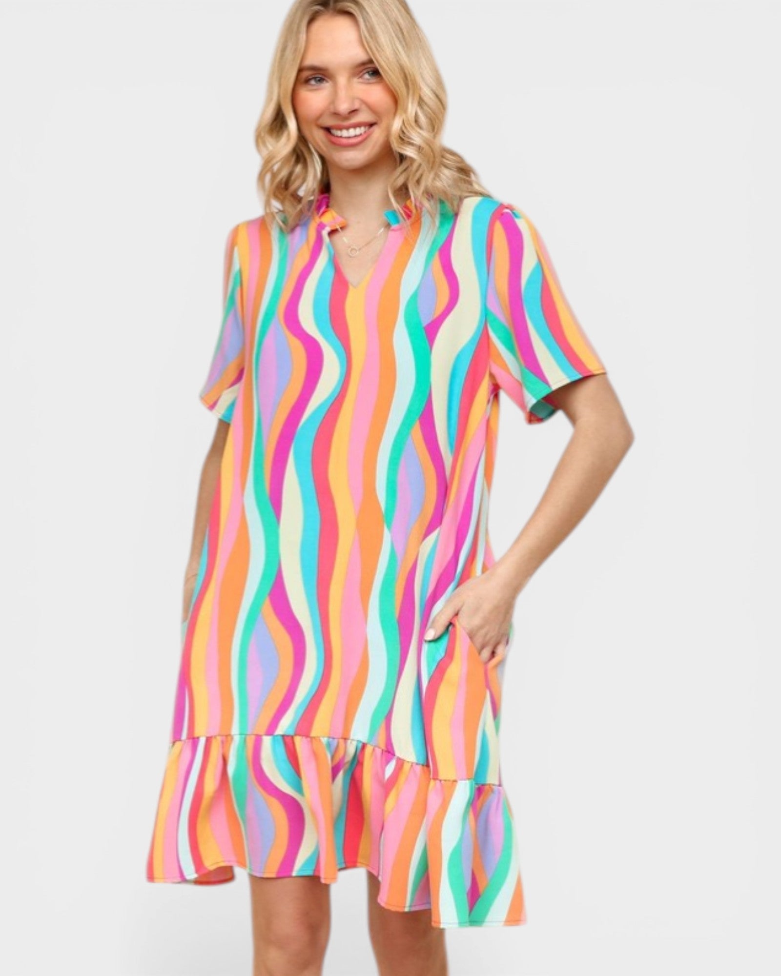 Woman wearing a colorful striped dress on a white background