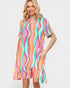 Woman wearing a colorful striped dress on a white background