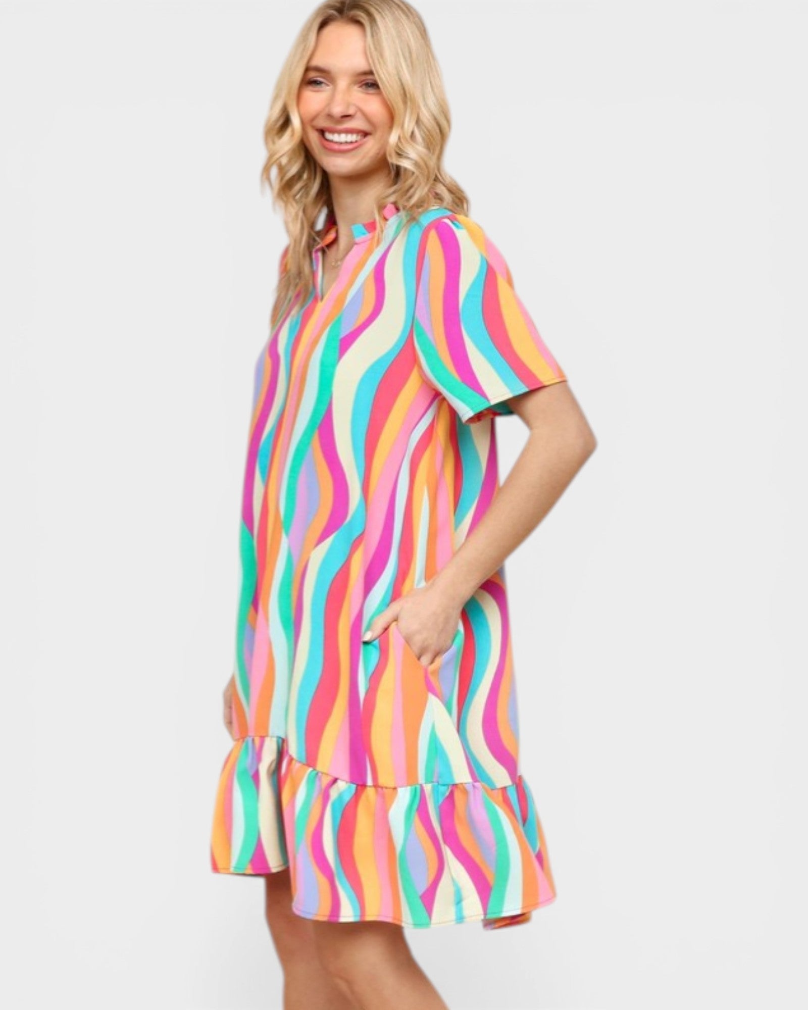 Woman wearing a colorful striped dress on a white background