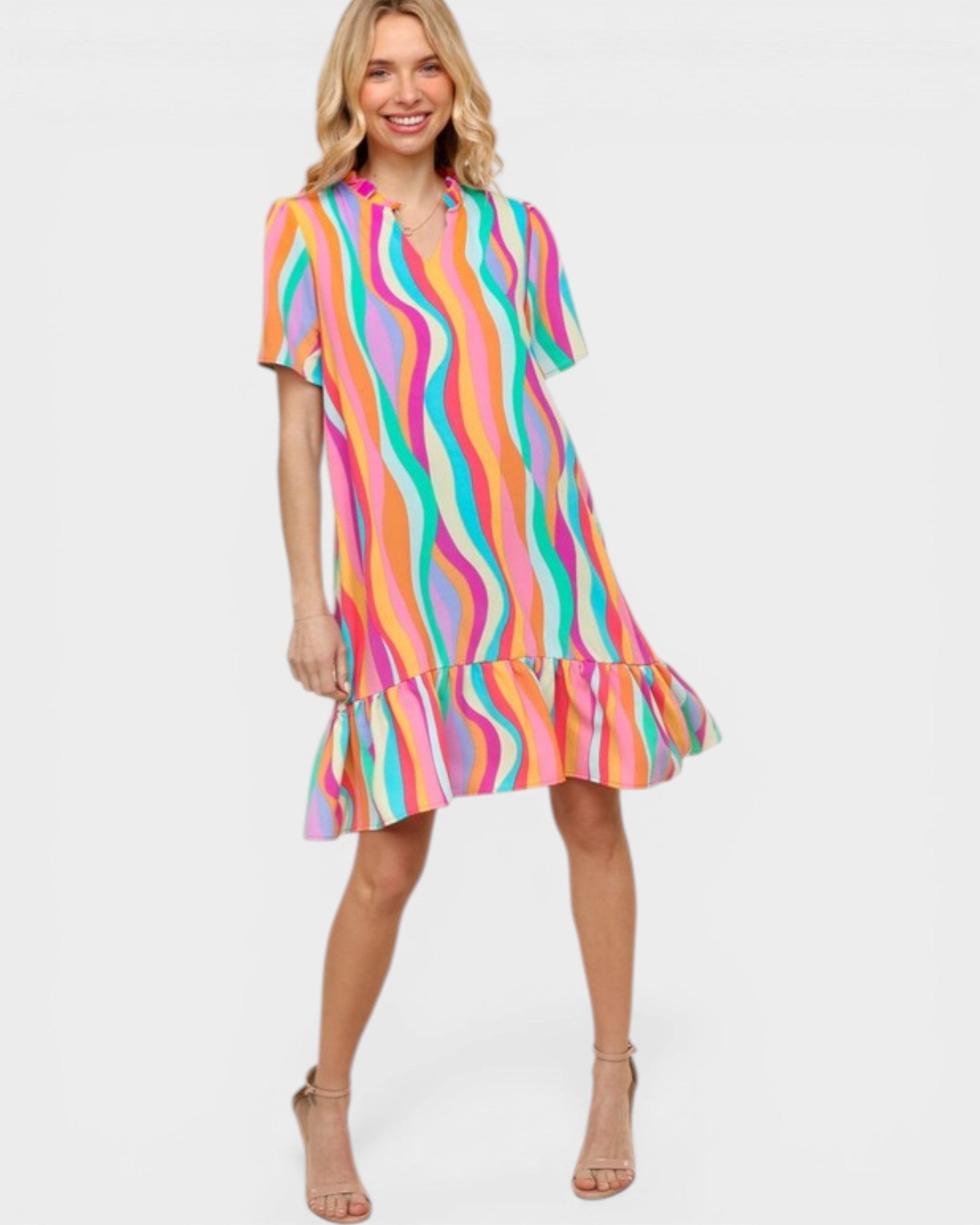 Woman wearing a colorful striped dress on a white background