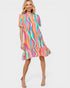 Woman wearing a colorful striped dress on a white background