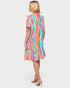 Woman wearing a colorful striped dress on a white background