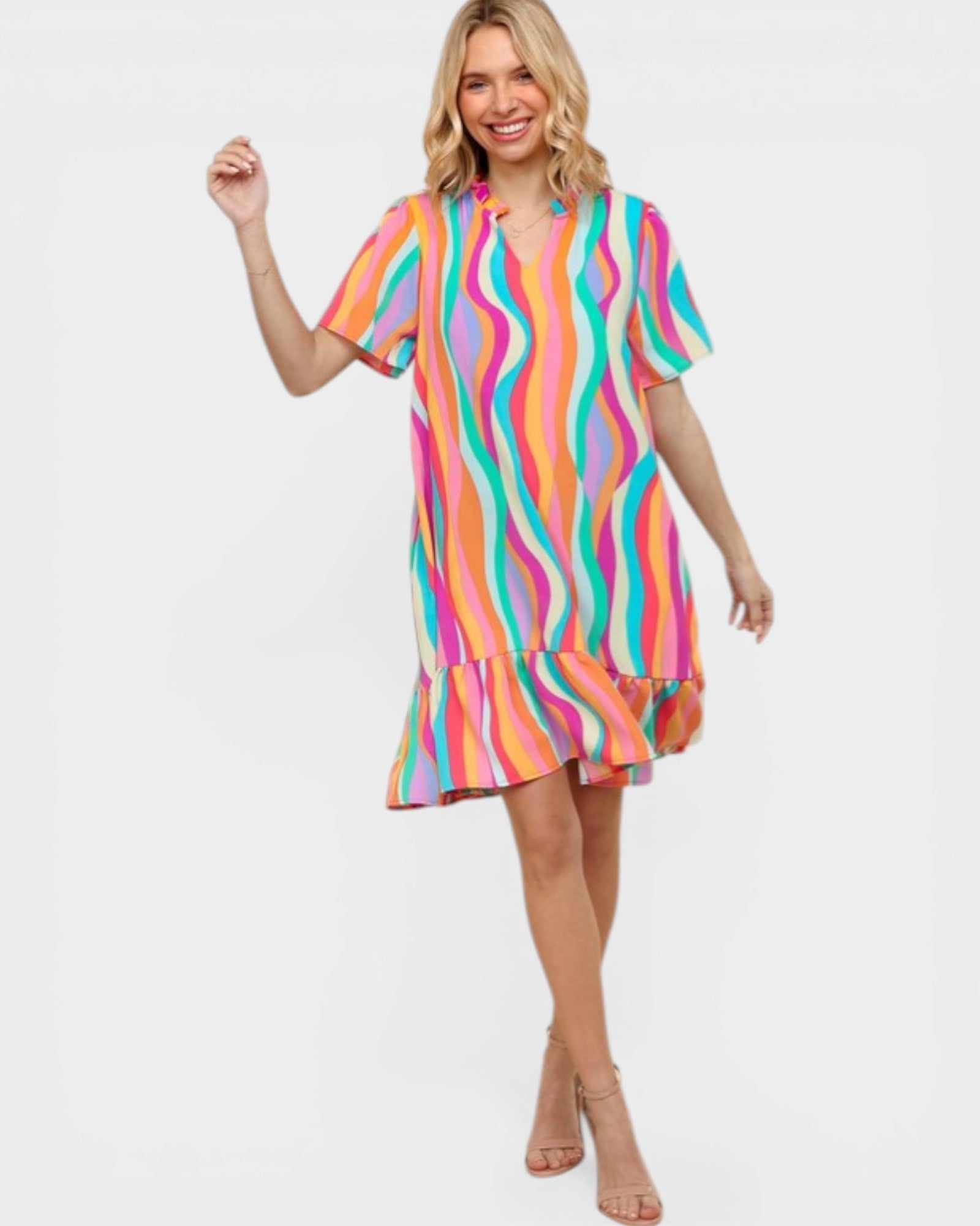 Woman wearing a colorful striped dress on a white background