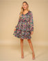 Woman wearing a floral dress on a beige background