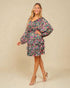 Woman wearing a floral dress on a beige background
