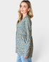 Woman wearing a blue floral blouse against a white background