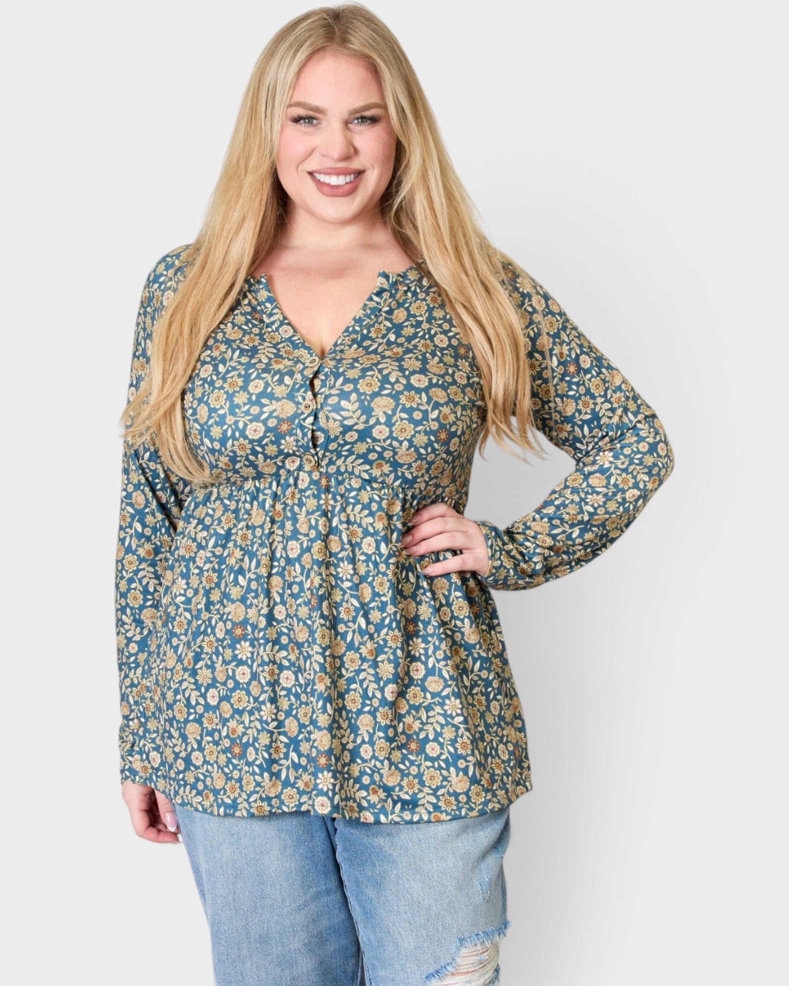 Woman wearing a floral blouse and jeans on a white background