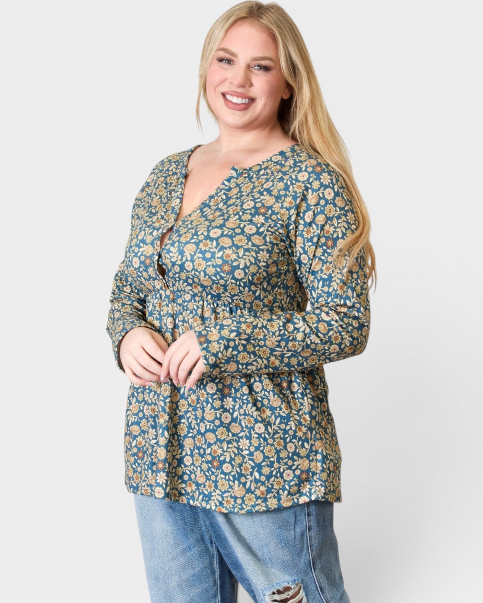 Woman wearing a floral blouse and jeans on a white background