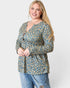 Woman wearing a floral blouse and jeans on a white background