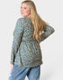 Woman wearing a floral blouse and jeans on a white background