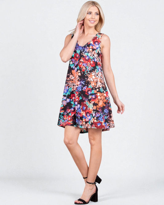 Woman wearing a colorful floral dress on a white background