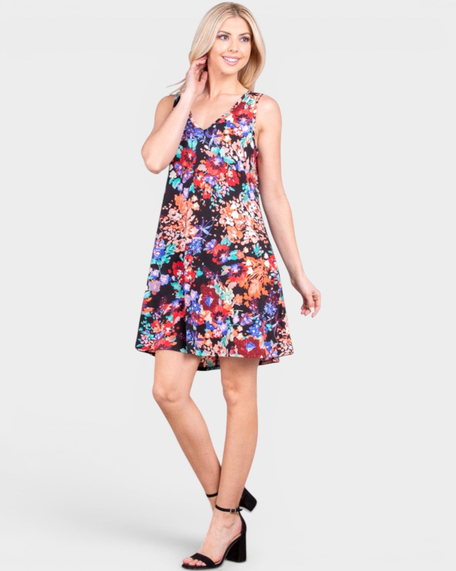 Woman wearing a colorful floral dress on a white background