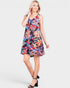 Woman wearing a colorful floral dress on a white background