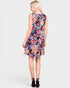 Woman wearing a colorful floral dress on a white background
