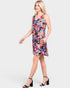 Woman wearing a colorful floral dress on a white background