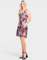 Woman wearing a colorful floral dress on a white background