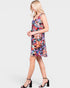 Woman wearing a colorful floral dress on a white background