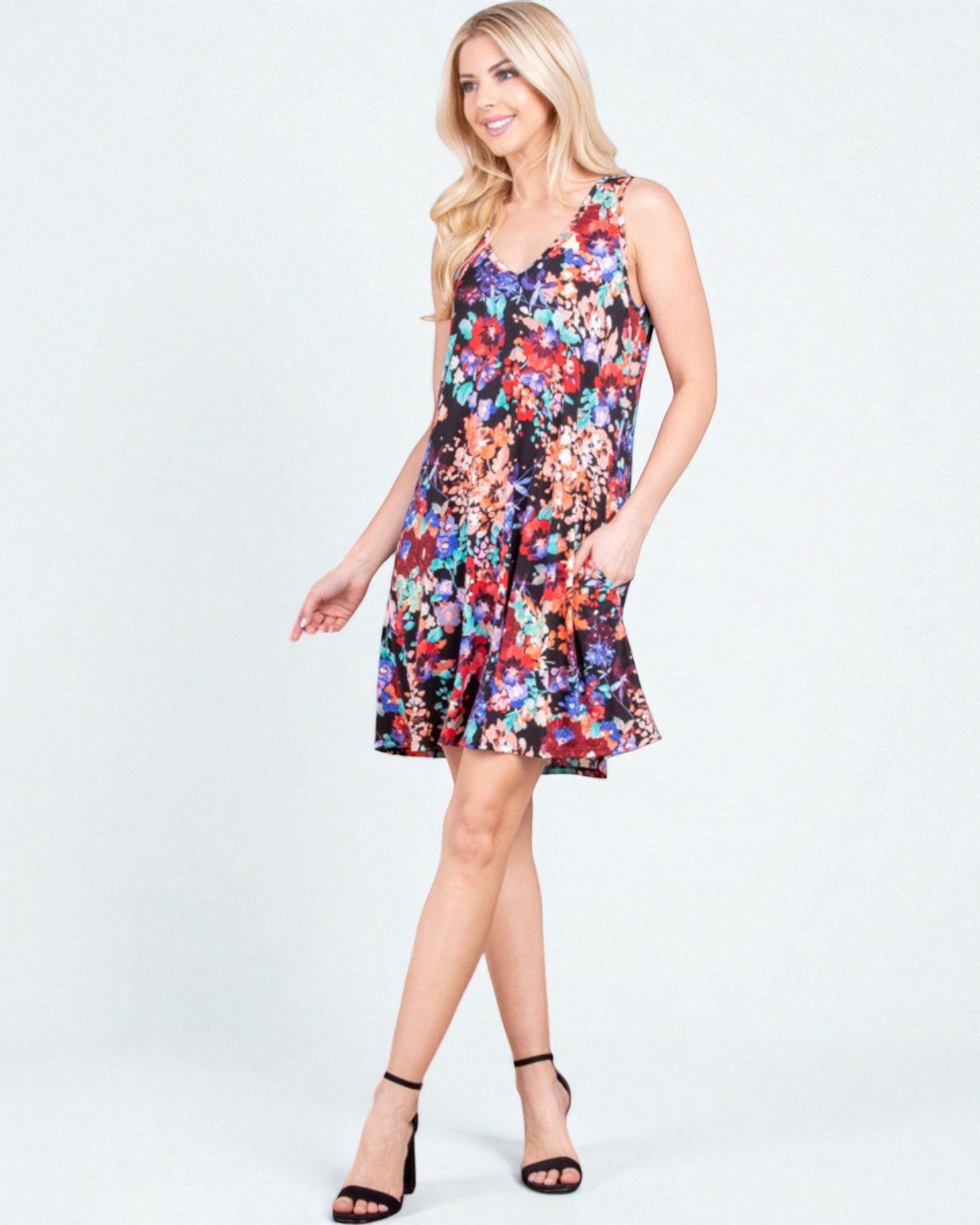 Woman wearing a colorful floral dress on a white background