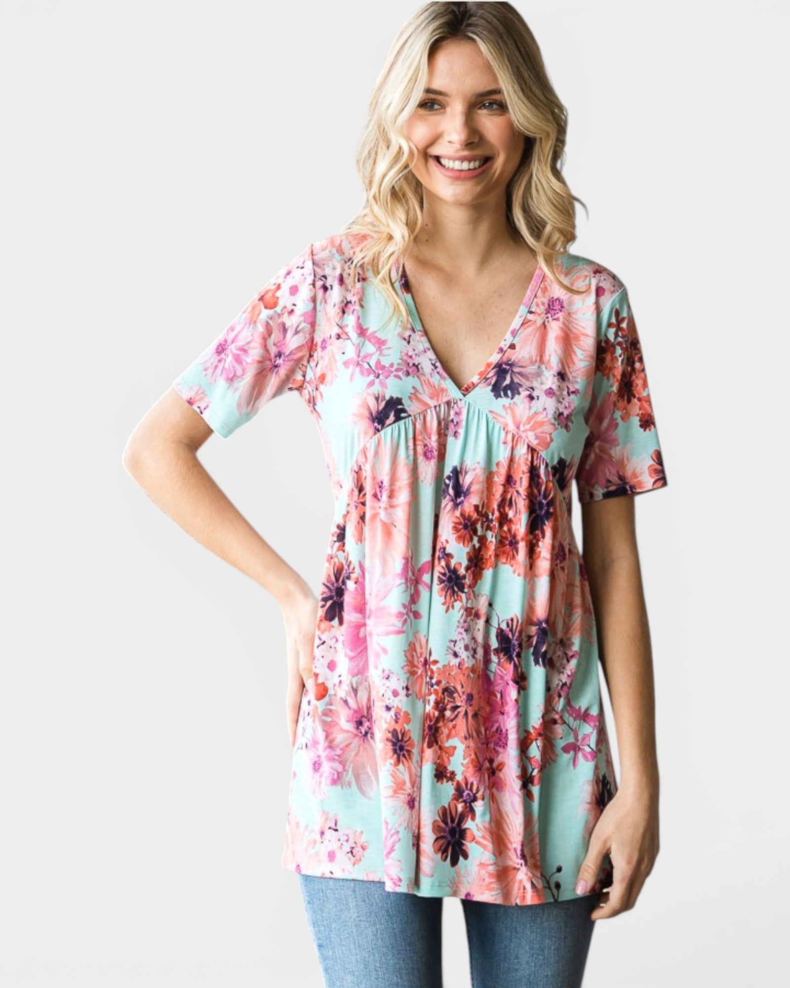 Woman wearing a floral print blouse on a plain background