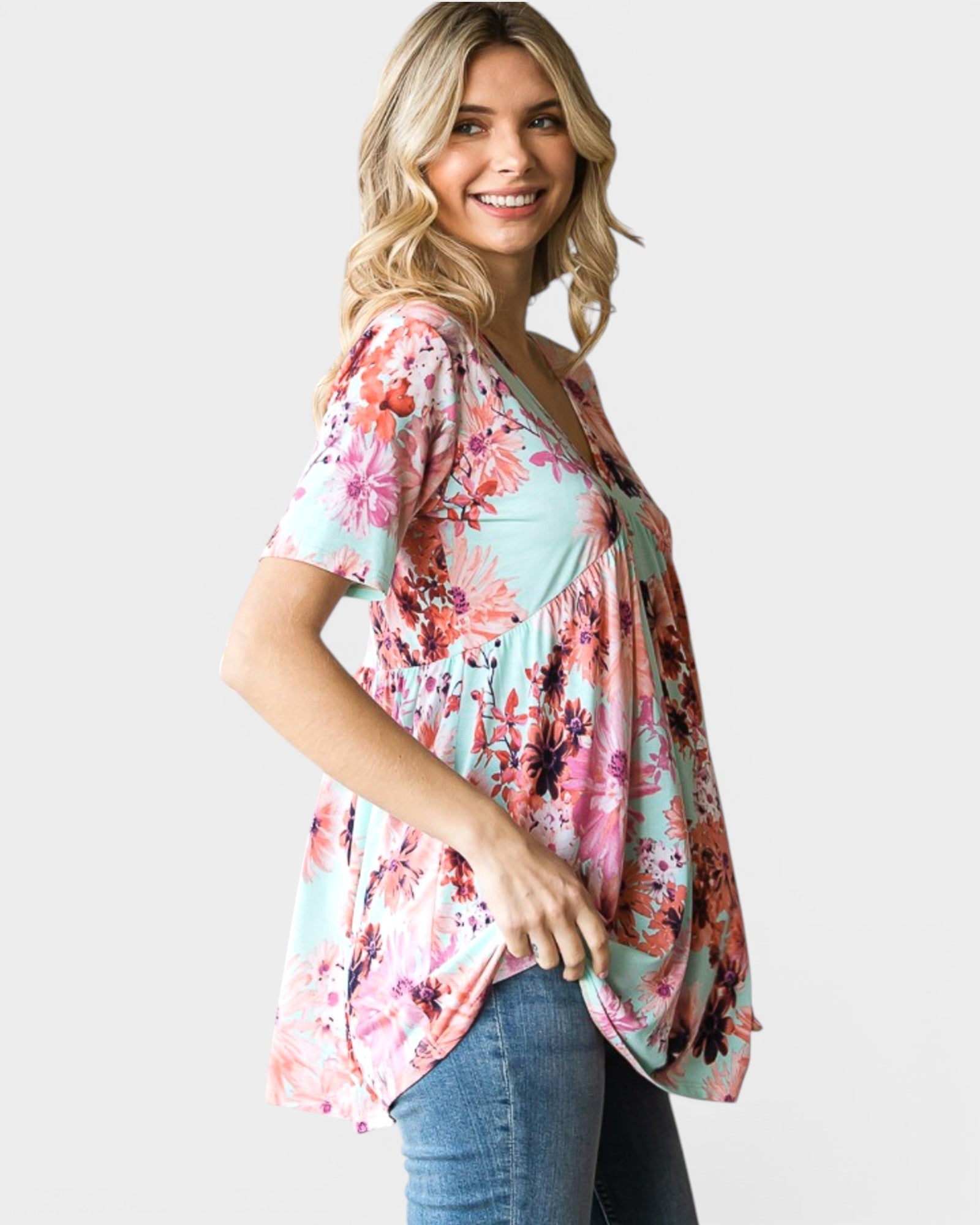 Woman wearing a floral blouse with a plain background