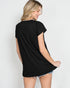Woman wearing a black t-shirt and denim shorts on a white background