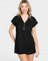 Woman wearing a black top with buttons on a white background
