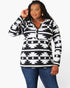 A woman modeling a long-sleeve black and white geometric patterned top with a split neckline and drawstring details, paired with blue jeans, against a plain white background.