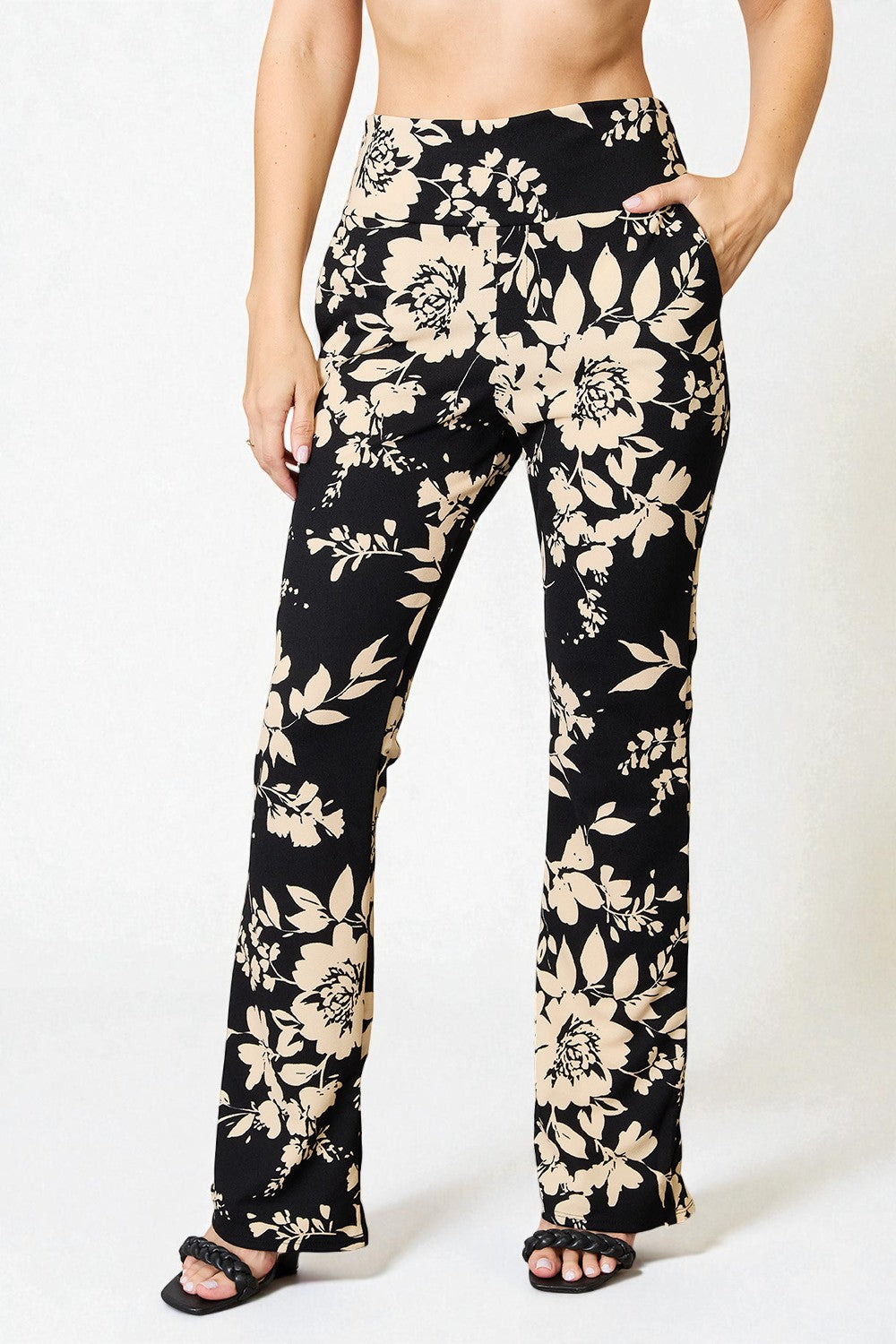 Floral-patterned pants worn by a person on a white background
