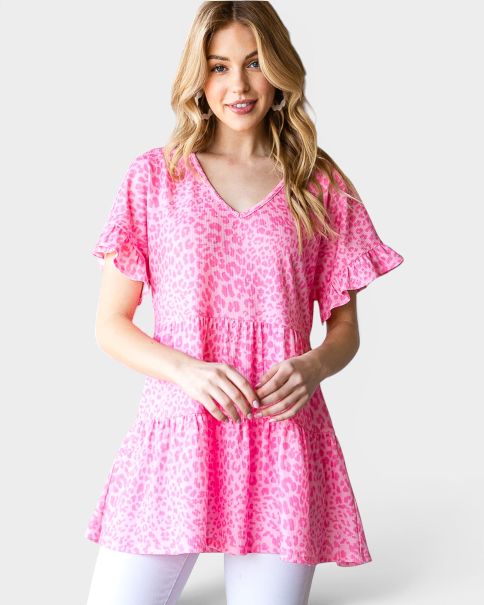 Woman wearing a pink patterned top on a white background