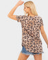 Woman wearing a leopard print top and denim shorts on a white background