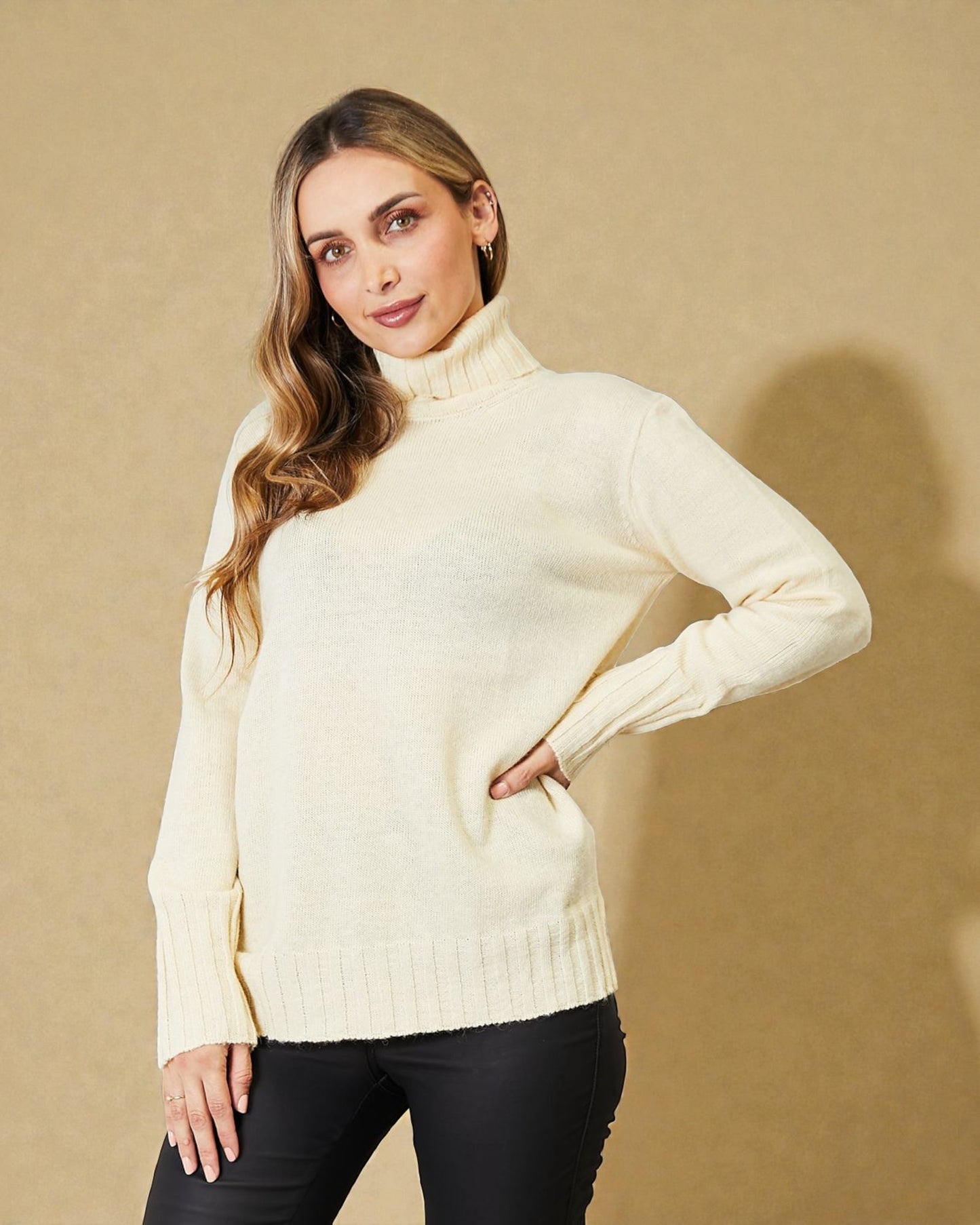 Woman wearing a cream sweater against a beige background
