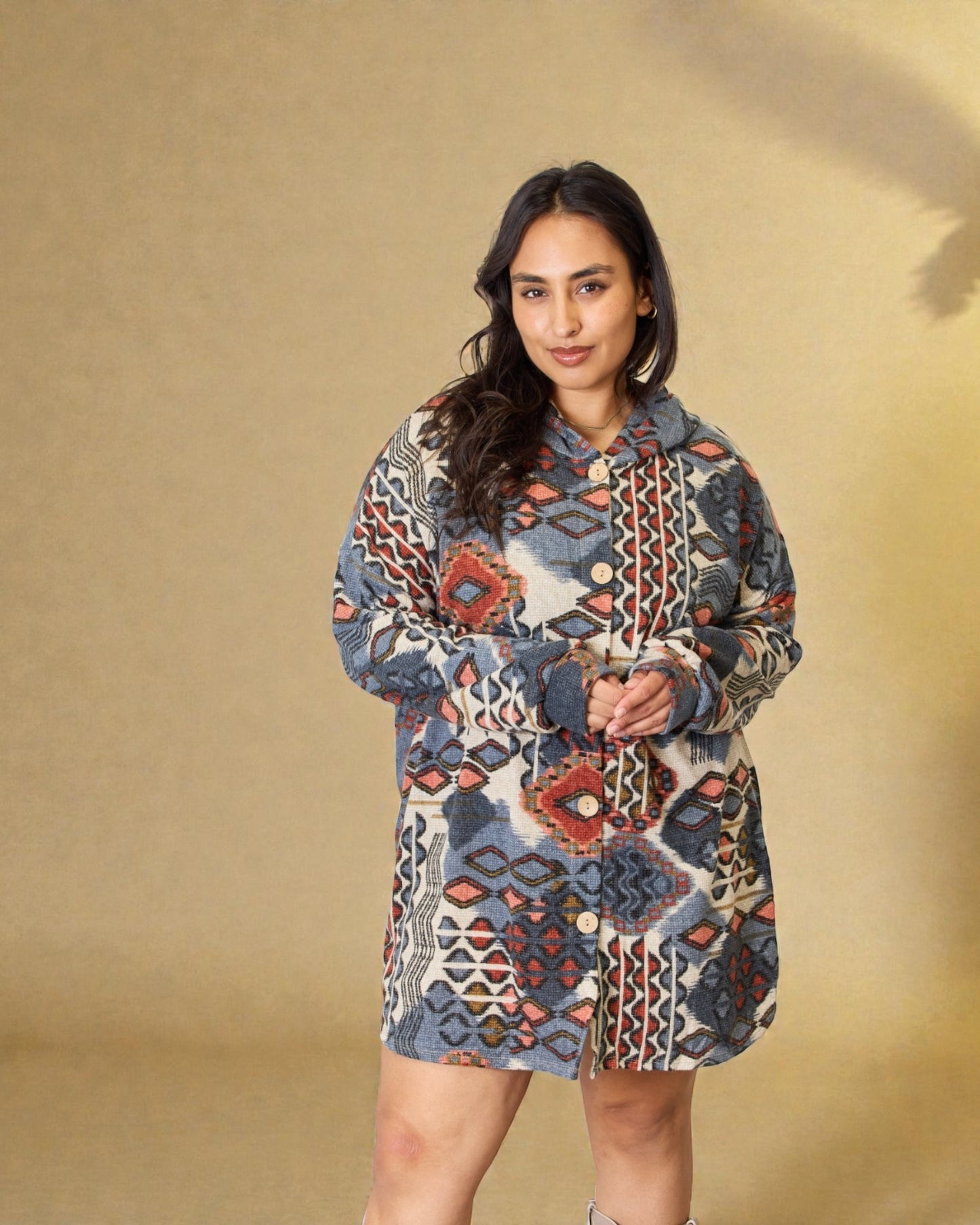 Woman wearing a patterned jacket against a beige background