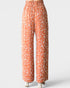 Orange pants with white leaf pattern on a white background
