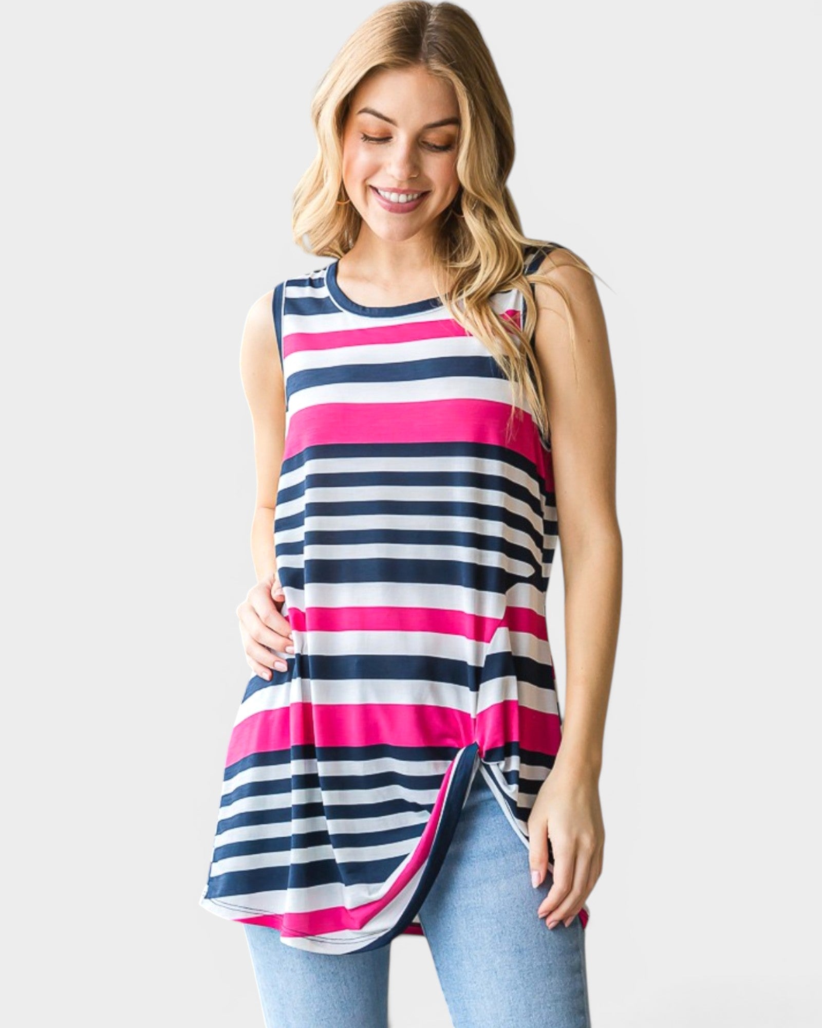 Woman wearing a sleeveless striped top with pink, white, and blue stripes on a plain background