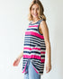 Woman wearing a sleeveless striped top with pink and navy horizontal stripes on a white background
