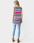 Woman wearing a sleeveless striped shirt and light blue jeans on a white background