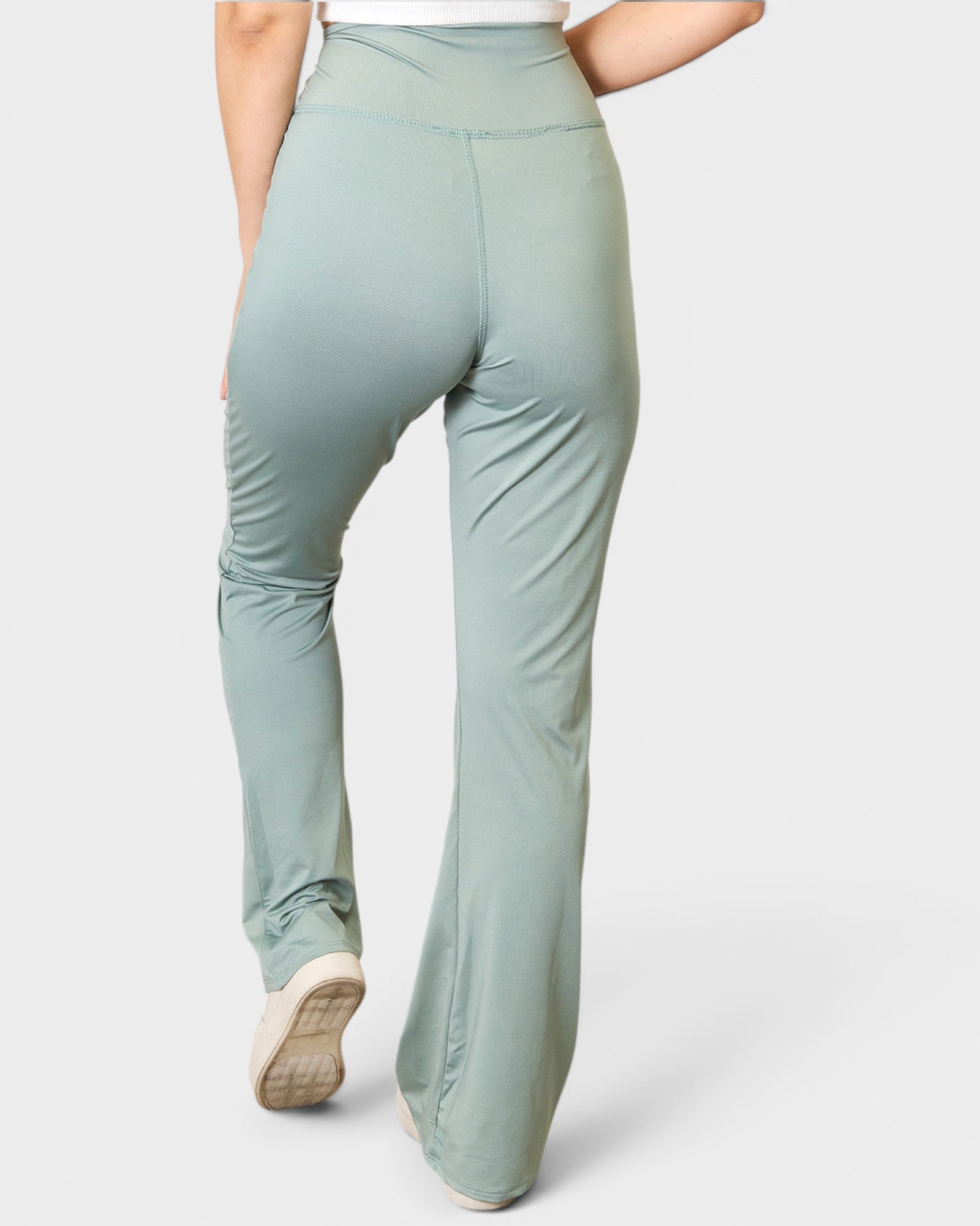 Light green pants worn by a person on a white background