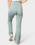 Light green pants worn by a person on a white background