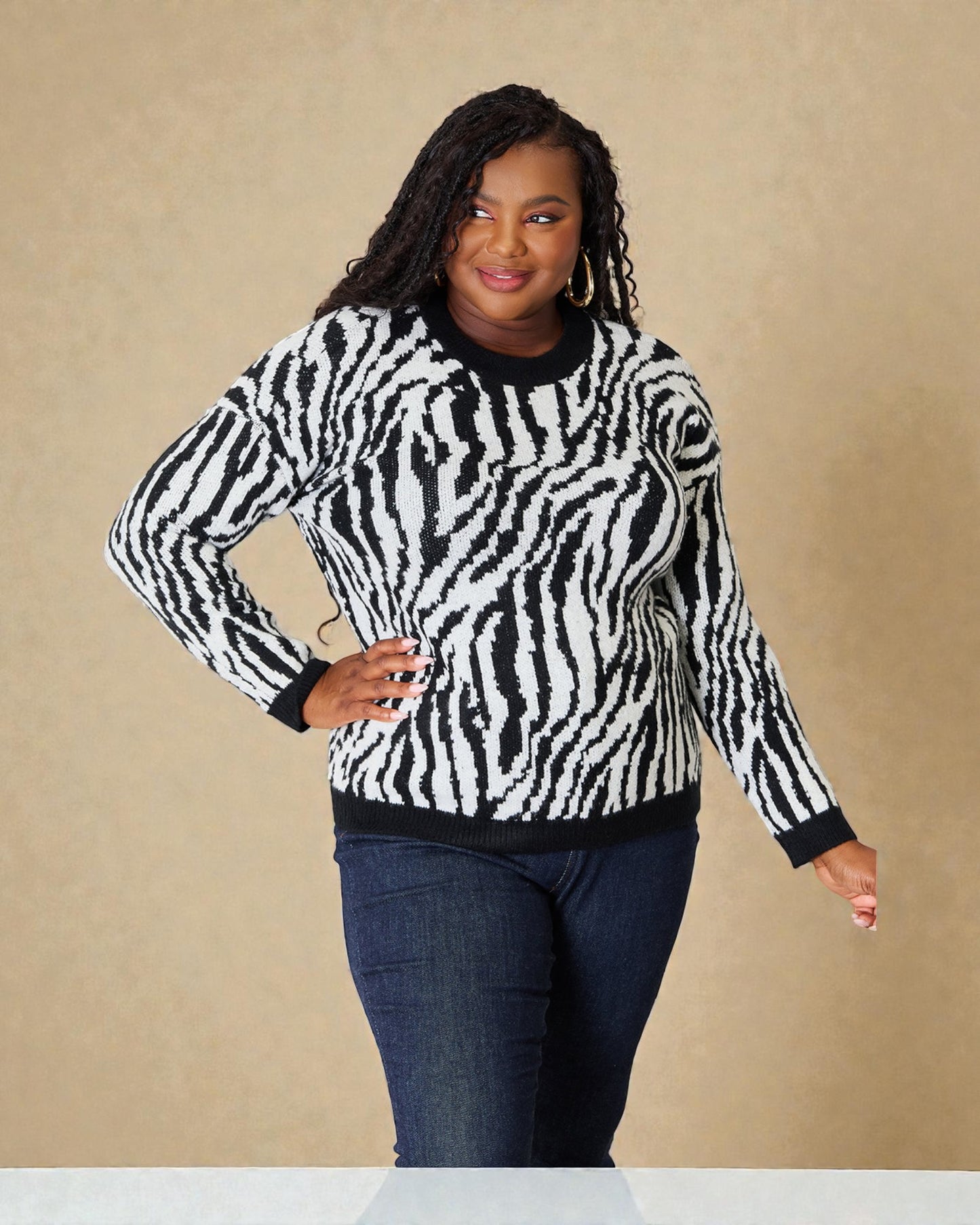 Woman wearing a zebra print sweater against a beige background