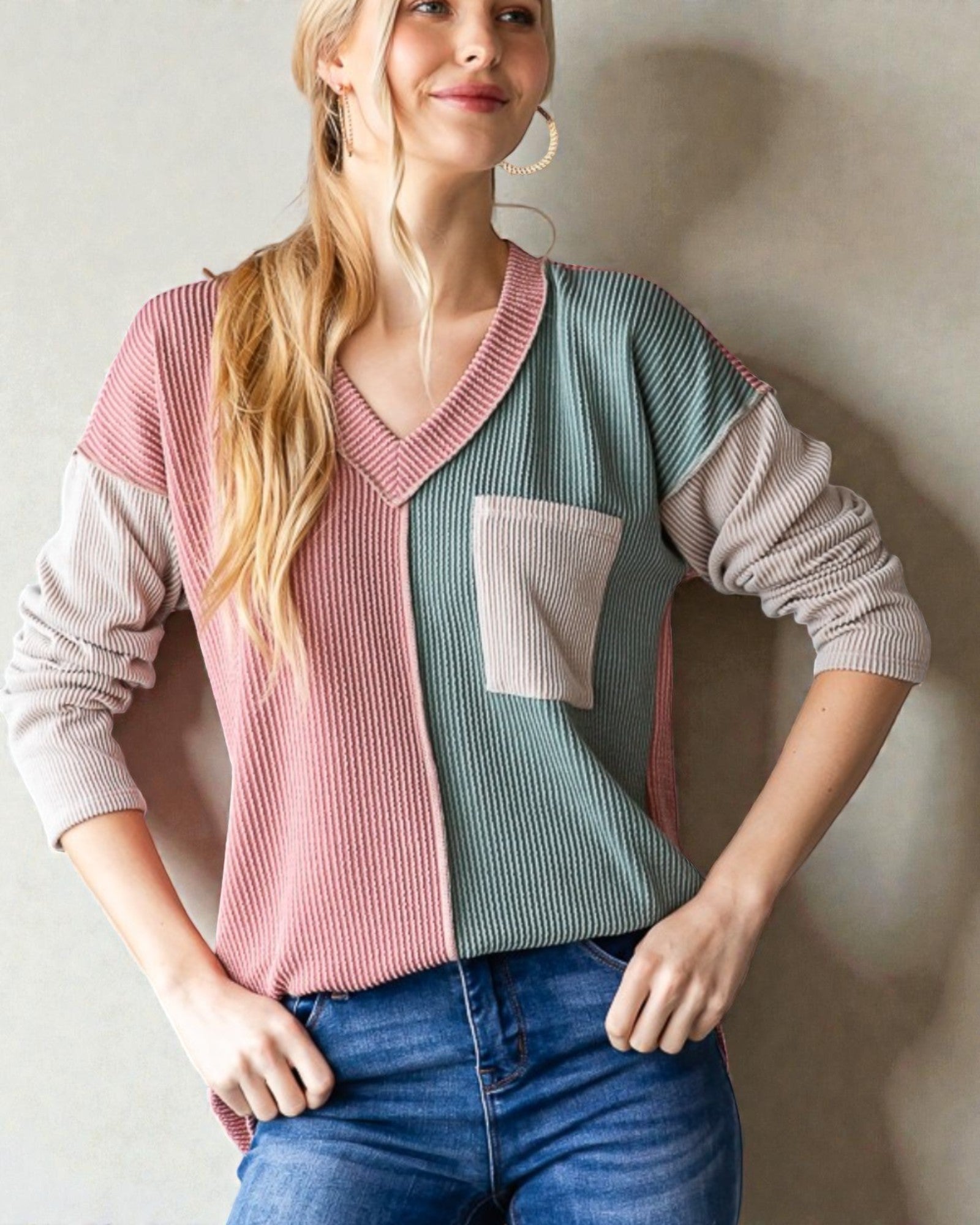 Woman wearing a colorful sweater with a neutral background