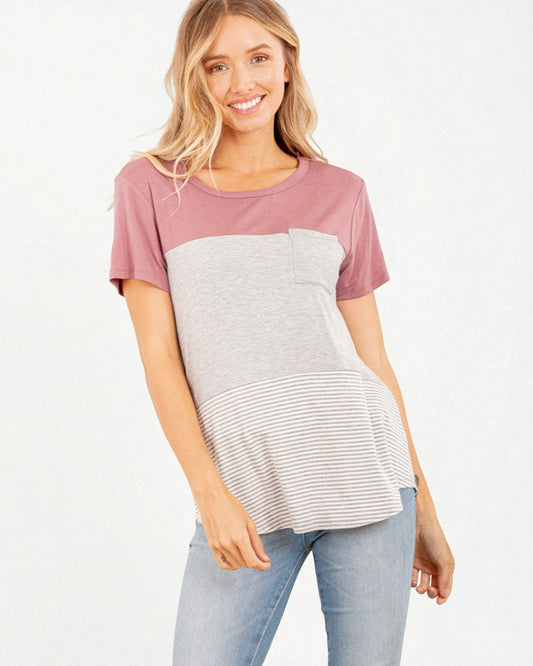 Woman wearing a two-tone shirt with pink sleeves and a grayish-white body on a white background