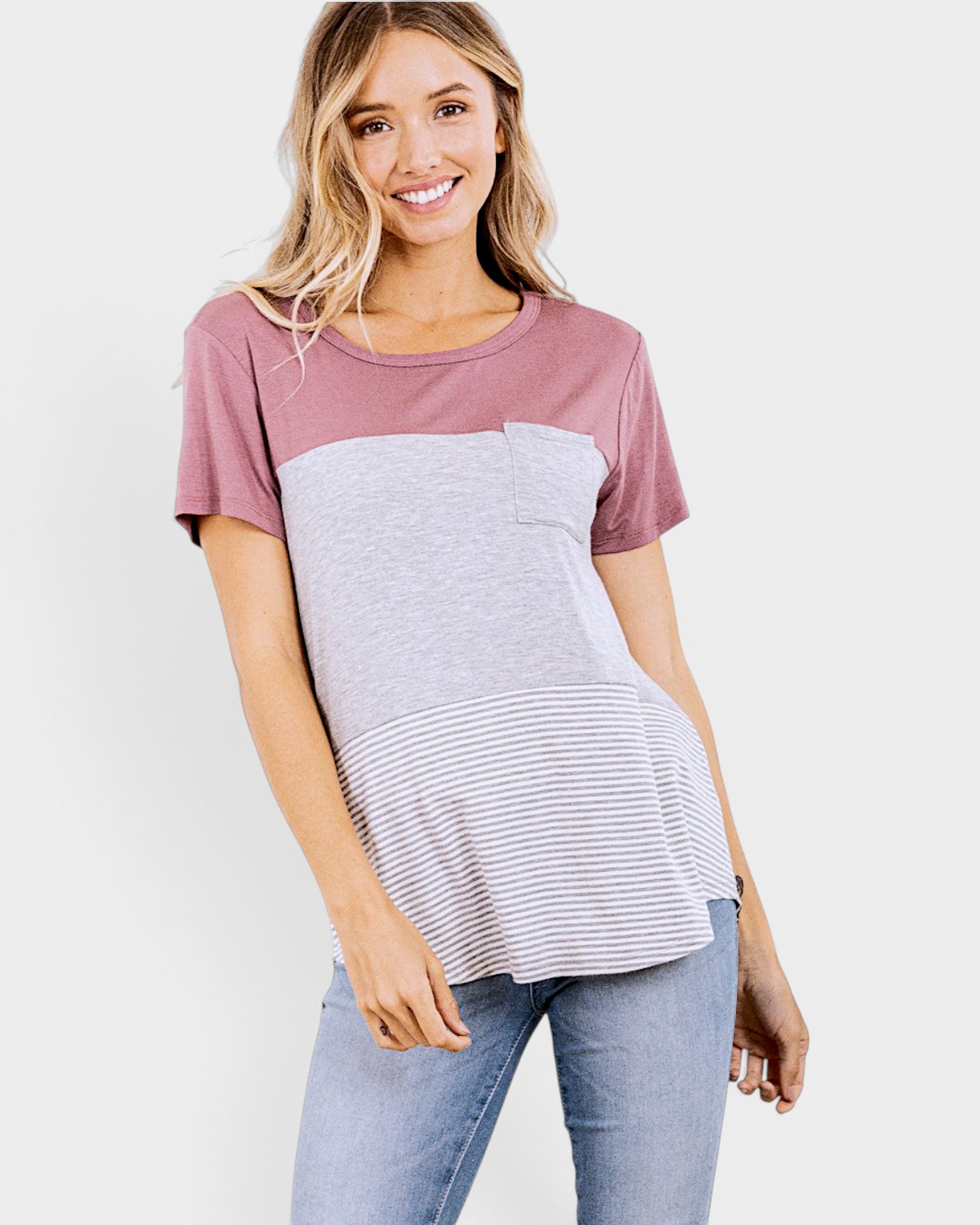 Woman wearing a two-tone shirt with a plain background