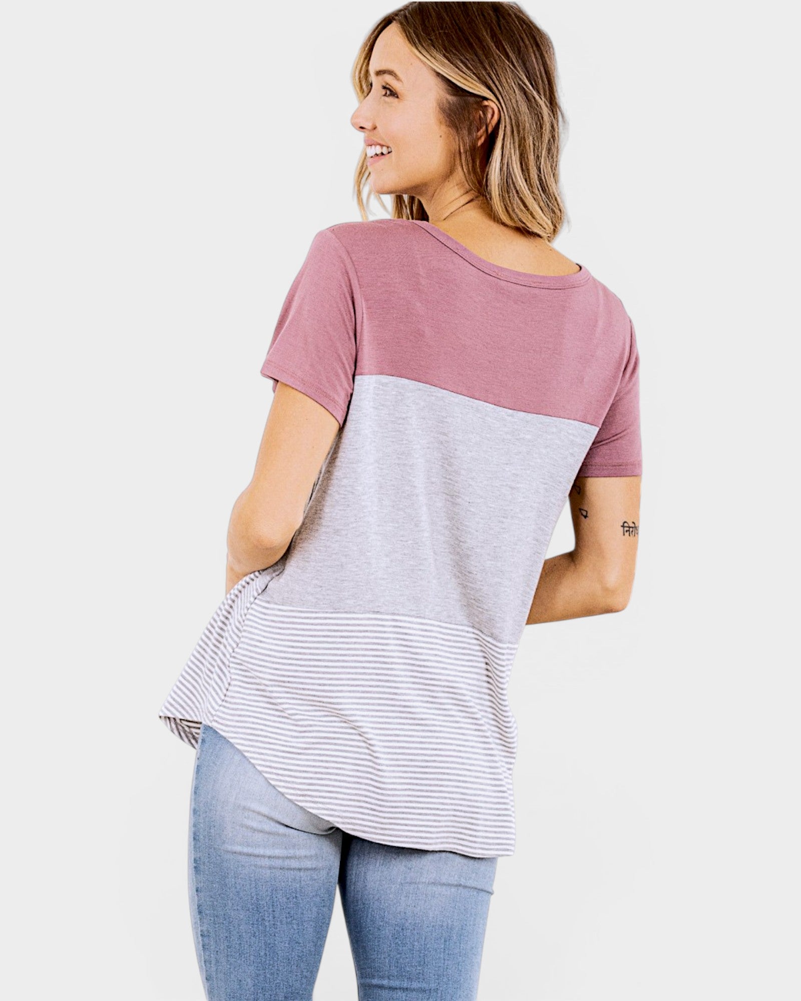 Woman wearing a two-tone t-shirt with a white background