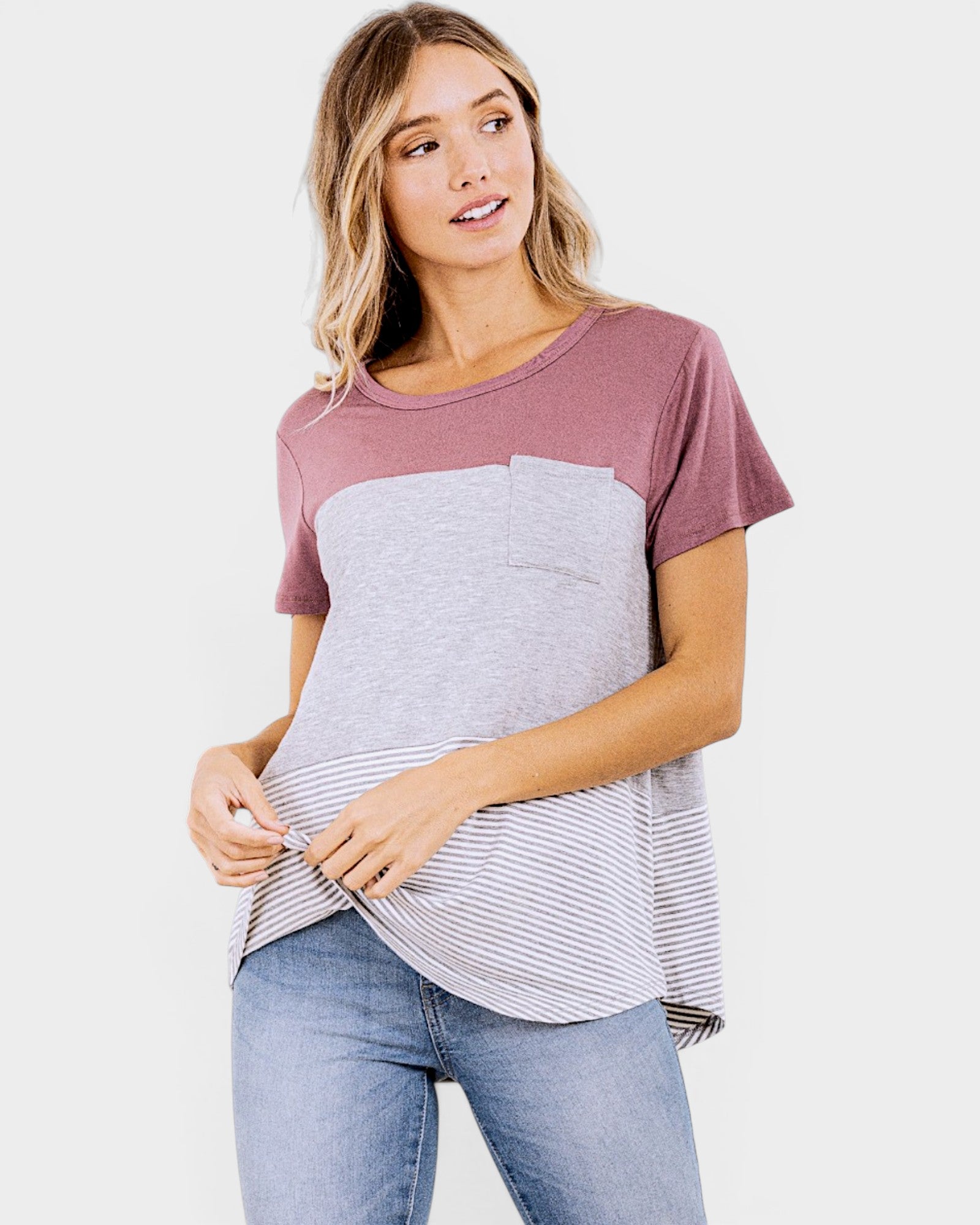Woman wearing a two-tone t-shirt with a plain background