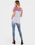 Woman wearing a two-tone shirt and jeans on a white background